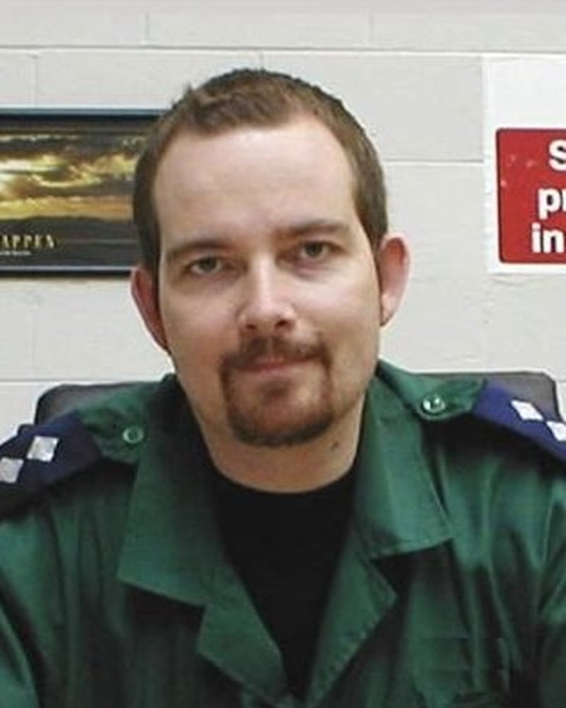 Mark Borrington as a newly-qualified NHS paramedic in the 1990s, wearing service uniform with epaulettes.